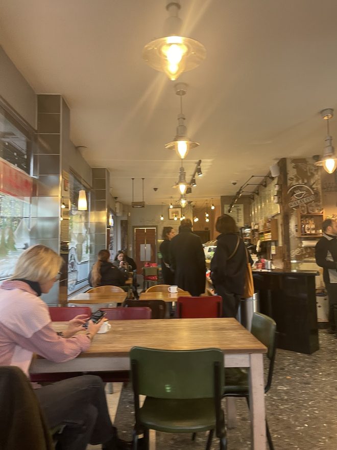 The dining room with pendant lights and a few seated customers