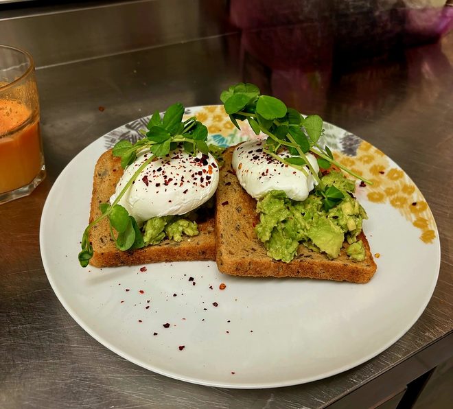 Avocado toast and a glass of juice shot from above